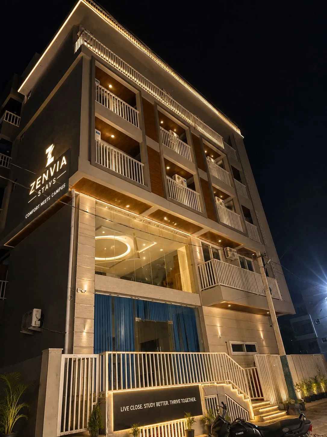 Zenvia Stays building lit up at night, near Manipal University, Jaipur